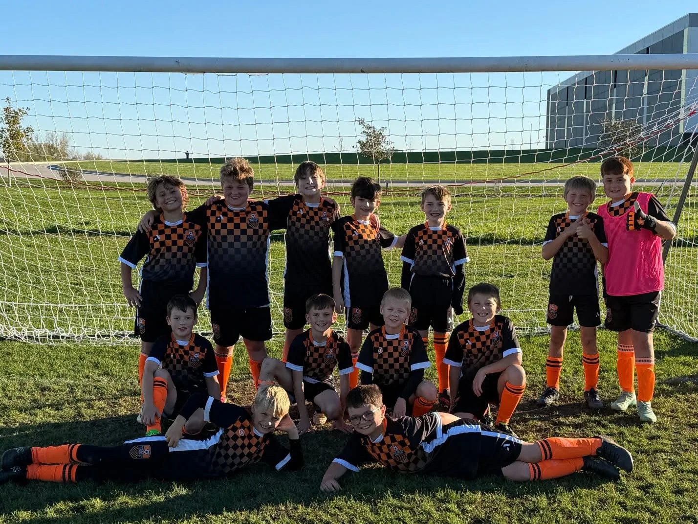 BUSC 11U boys Orange team together on the soccer field